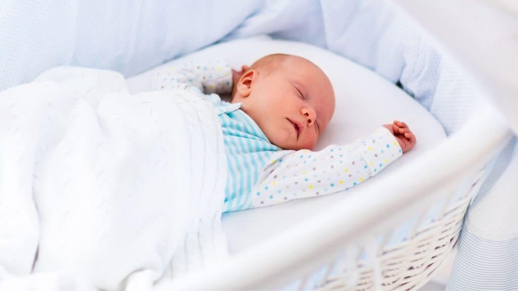 baby sleeping in bassinet