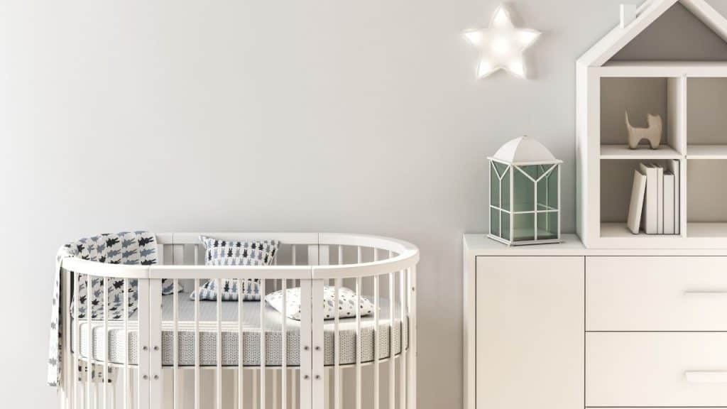 mini crib with rounded sides and mattress