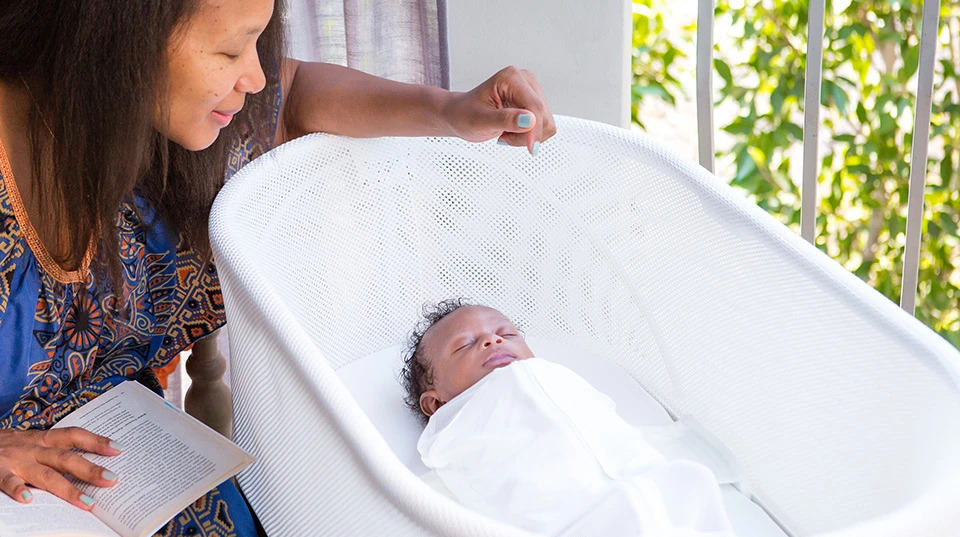 mom watching baby in the SNOO smart sleeper