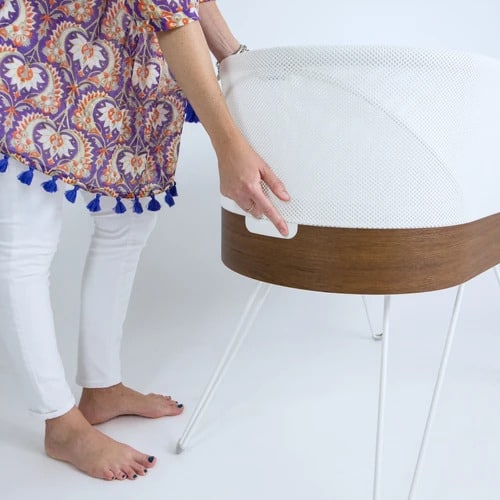 mom holding snoo smart bassinet 