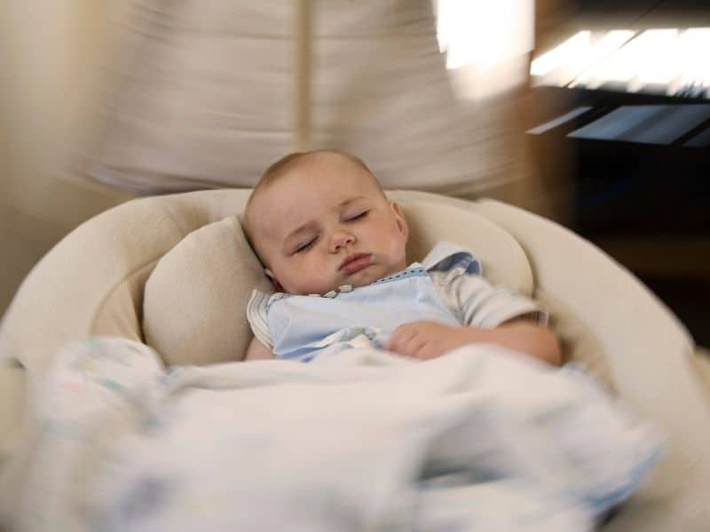 baby sleeping in baby swing