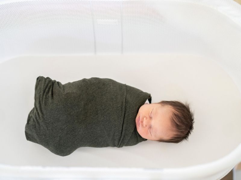 baby sleeping in a bassinet