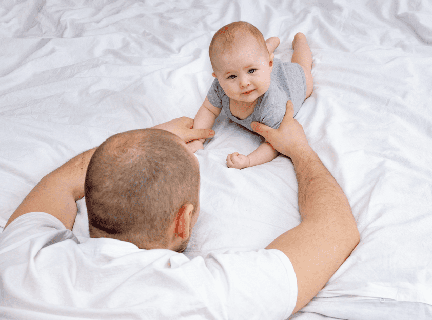 Baby playing with his dad