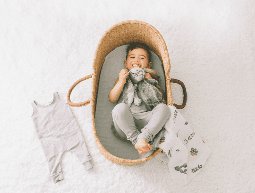 Kid laying a bassinet